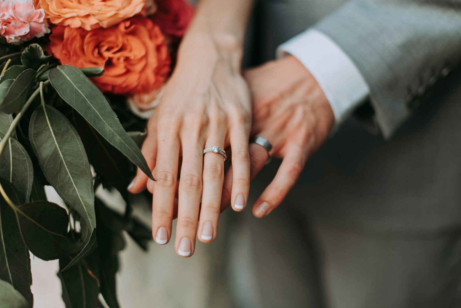 Couple holding hands with flowers